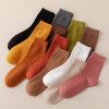 Bright colorful socks in black, gray, mustard, brown, green, white, beige, and pink displayed on a neutral background—perfect for stylish everyday wear and comfortable fit.