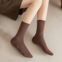 Comfy brown ribbed socks on a person's feet, showcasing cozy and warm footwear perfect for winter or casual wear.
