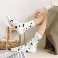 Cozy cow print fuzzy socks with adorable black and white cow designs, perfect for comfortable wear and stylish indoor fashion at Monalisa Store.