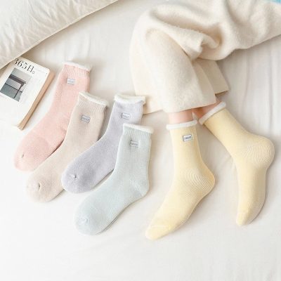 Colorful pastel ankle socks displayed on a white bed with a magazine, ideal for comfortable everyday wear and eye care accessories from Monalisa Store.