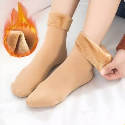 Soft beige orthotic socks with plush fur lining, ideal for foot comfort and medical use, showcased on a mannequin foot with a fiery graphic emphasizing warmth and therapeutic relief.