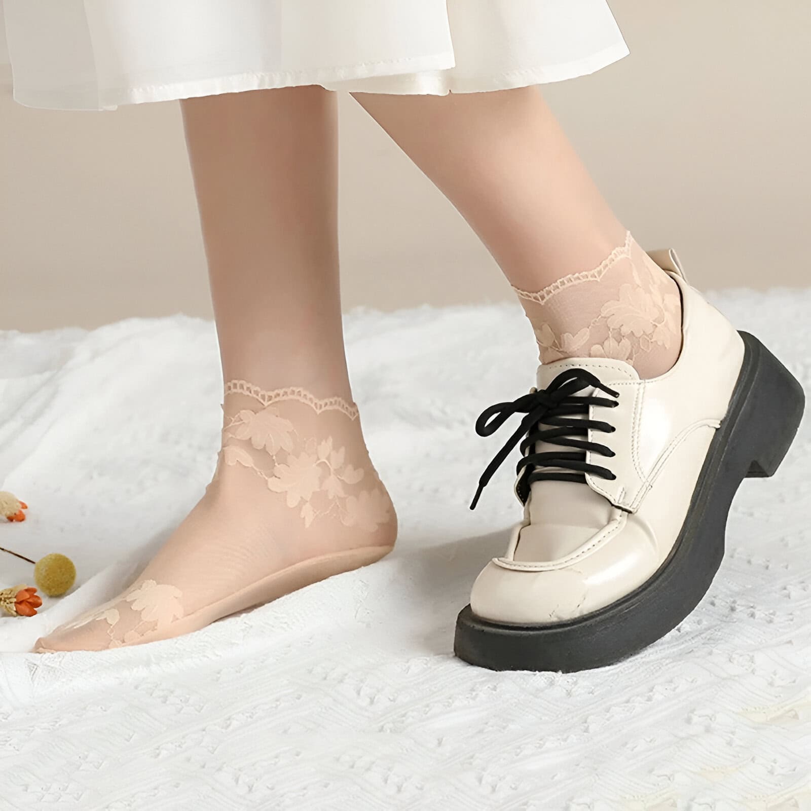 Soft peach lace ankle socks paired with stylish cream platform sneakers for a trendy, casual look. Perfect for those who enjoy combining comfort with fashion in their everyday wardrobe.