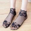 Elegant black lace footie socks with floral embroidery, perfect for stylish and comfortable wear; available at Monalisa Store.