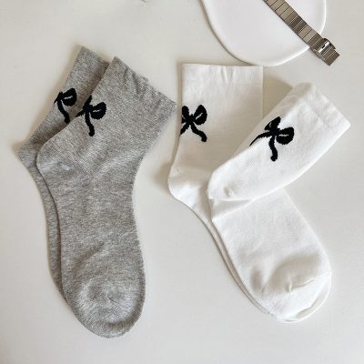 Soft cotton socks with black bow design, available in gray and white, perfect for casual wear and style.