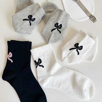 Monalisa store socks with bow logo in various colors, perfect for elegant and comfortable footwear, ideal for casual and formal wear.