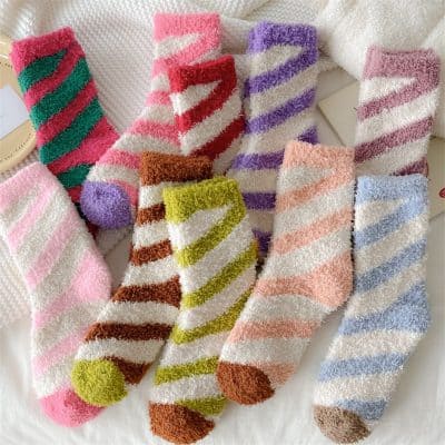 Pink, purple, green, striped fuzzy socks for women and girls, cozy and colorful, ideal for cold weather, fashionable and comfortable footwear option.