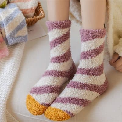 Cozy pink and cream striped fuzzy socks with orange tips, perfect for winter warmth and comfort at Monalisa Store.