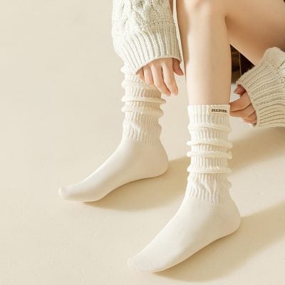 Comfy cream-colored knit socks and cozy matching sweater from Monalisa Store, perfect for stylish comfort and winter warmth.