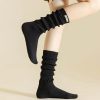 Comfy black knee-high socks for women, casual athletic footwear, Monalisa Store, versatile sock fashion, comfortable legwear for everyday use.