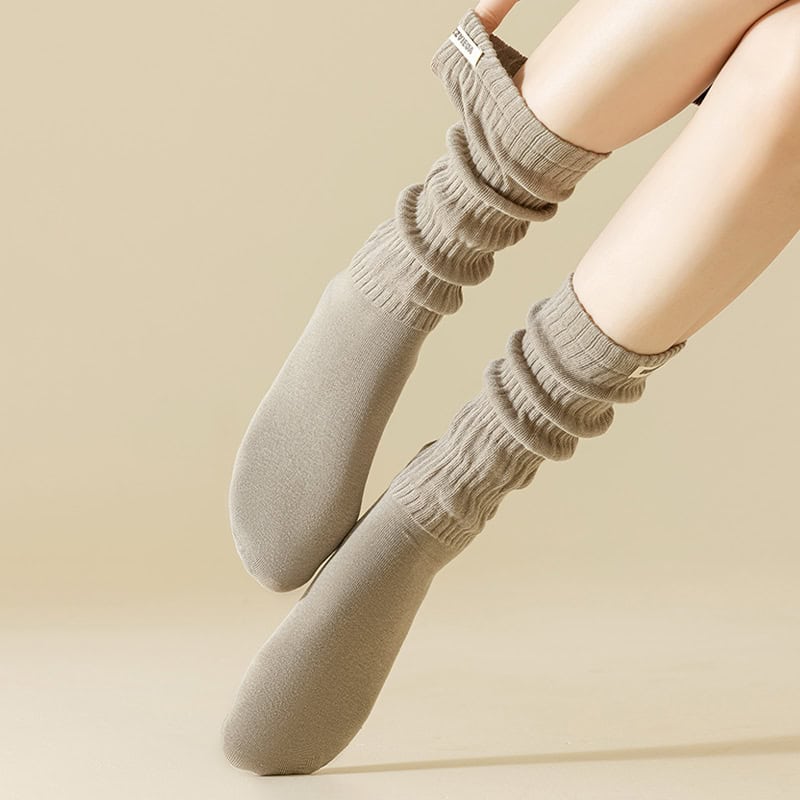 Comfy beige knee-high socks showcased in a stylish fashion, perfect for casual or cozy apparel options.