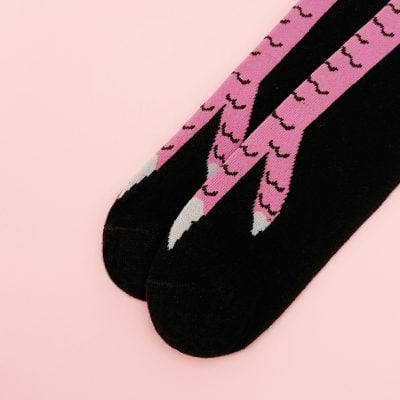 Pink flamingo patterned socks on black background, stylish and comfortable for everyday wear. Perfect for fashion-forward individuals seeking fun and unique sock designs.