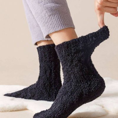Soft black fuzzy slippers showcasing cozy comfort, ideal for indoor use and relaxation, paired with casual loungewear for a stylish yet comfortable look.
