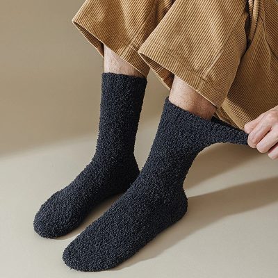Comfy black cozy socks for men and women, perfect for relaxation and warmth.
