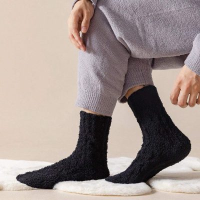 Cozy black fuzzy socks shown on a person's feet, perfect for comfortable and stylish loungewear or medical-themed attire at Monalisa Store.