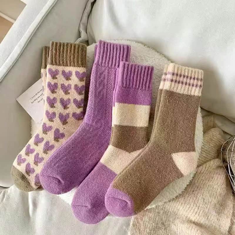 Colorful cozy wool socks with heart and striped patterns, ideal for winter comfort and fashion. Perfect for casual wear, pairing with sneakers or boots for a stylish, warm look.