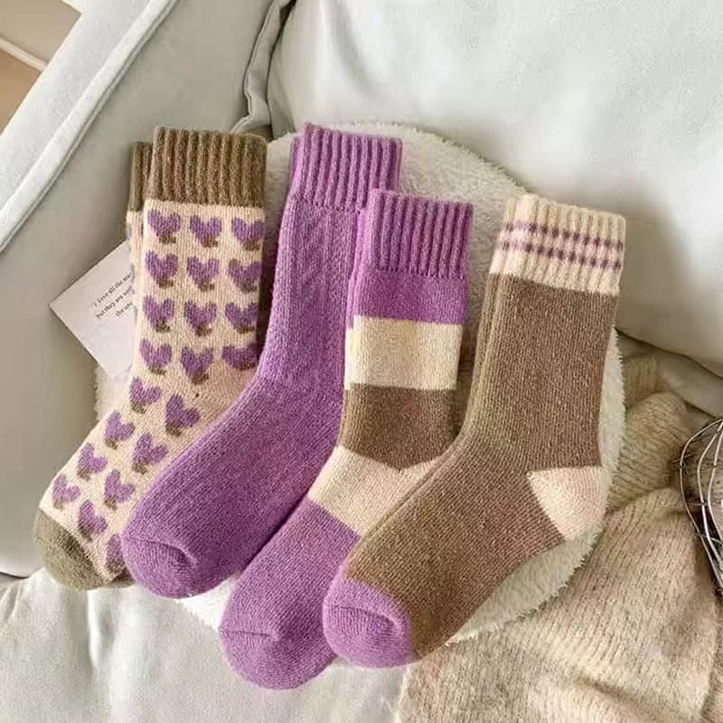Colorful cozy socks with heart and geometric patterns, perfect for winter comfort and stylish everyday wear.