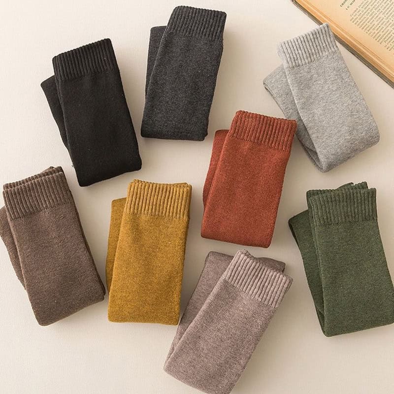 Soft cashmere socks in various colors arranged on a white surface for cozy winter wear at Monalisa Store.