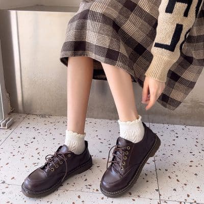 Comfy leather platform shoes with chunky soles paired with stylish plaid skirt and cozy knit socks at Mona Lisa Store.