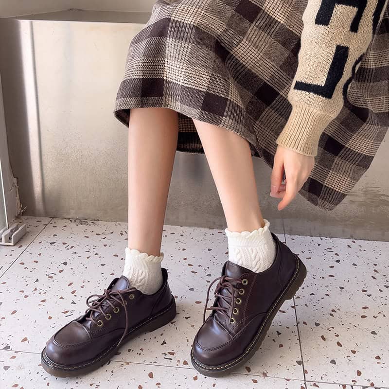 Comfy leather platform shoes with chunky soles paired with stylish plaid skirt and cozy knit socks at Mona Lisa Store.