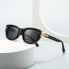 Black designer sunglasses with gold accents, perfect for fashionable eye protection and UV defense.
