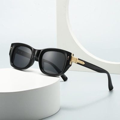 Black designer sunglasses with gold accents, perfect for fashionable eye protection and UV defense.