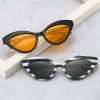 Elegant fashion sunglasses featuring bold black and white striped frames with dark and orange tinted lenses, perfect for stylish sun protection at Monalisa Store.