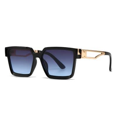 Luxury designer sunglasses with black frames and tinted blue lenses, featuring gold accents on the temples, perfect for stylish summer accessories.