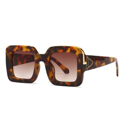 Tortoiseshell square sunglasses with gradient lenses and gold accents, perfect for fashion-forward eye protection and style.