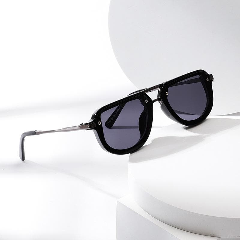 Black designer sunglasses with dark tinted lenses on a white geometric background suitable for fashion and eye protection.