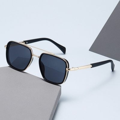 Elegant designer sunglasses with black lenses and gold frame, perfect for stylish eye protection and UV shielding. Ideal for fashion-forward individuals and optical accessory enthusiasts.