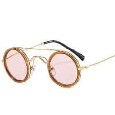 Round vintage style sunglasses with pink tinted lenses, gold metal frame, and adjustable nose pads, perfect for fashion-forward sun protection and everyday eyewear.