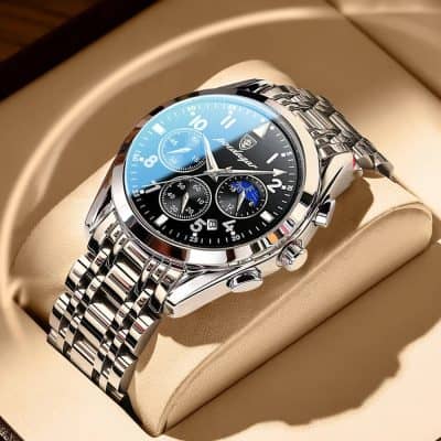 Men's luxury chronograph watch featuring stainless steel bracelet, black dial with blue accents, and multiple sub-dials for precise timekeeping, displayed in an elegant beige watch box.