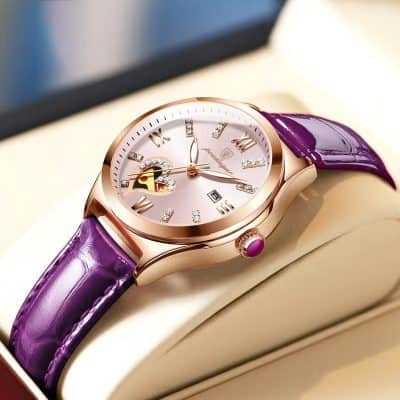 Luxury women’s watch with pink dial, rose gold case, and purple leather strap, featuring crystal accents and date display. Perfect for elegant style and high-end accessories.