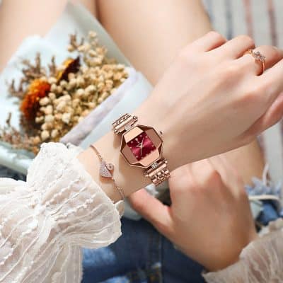 Elegant rose gold watch with a red dial, paired with a delicate diamond ring and bracelet, showcasing luxurious accessories from Monalisa Store. Perfect for stylish women seeking high-quality jewelry.