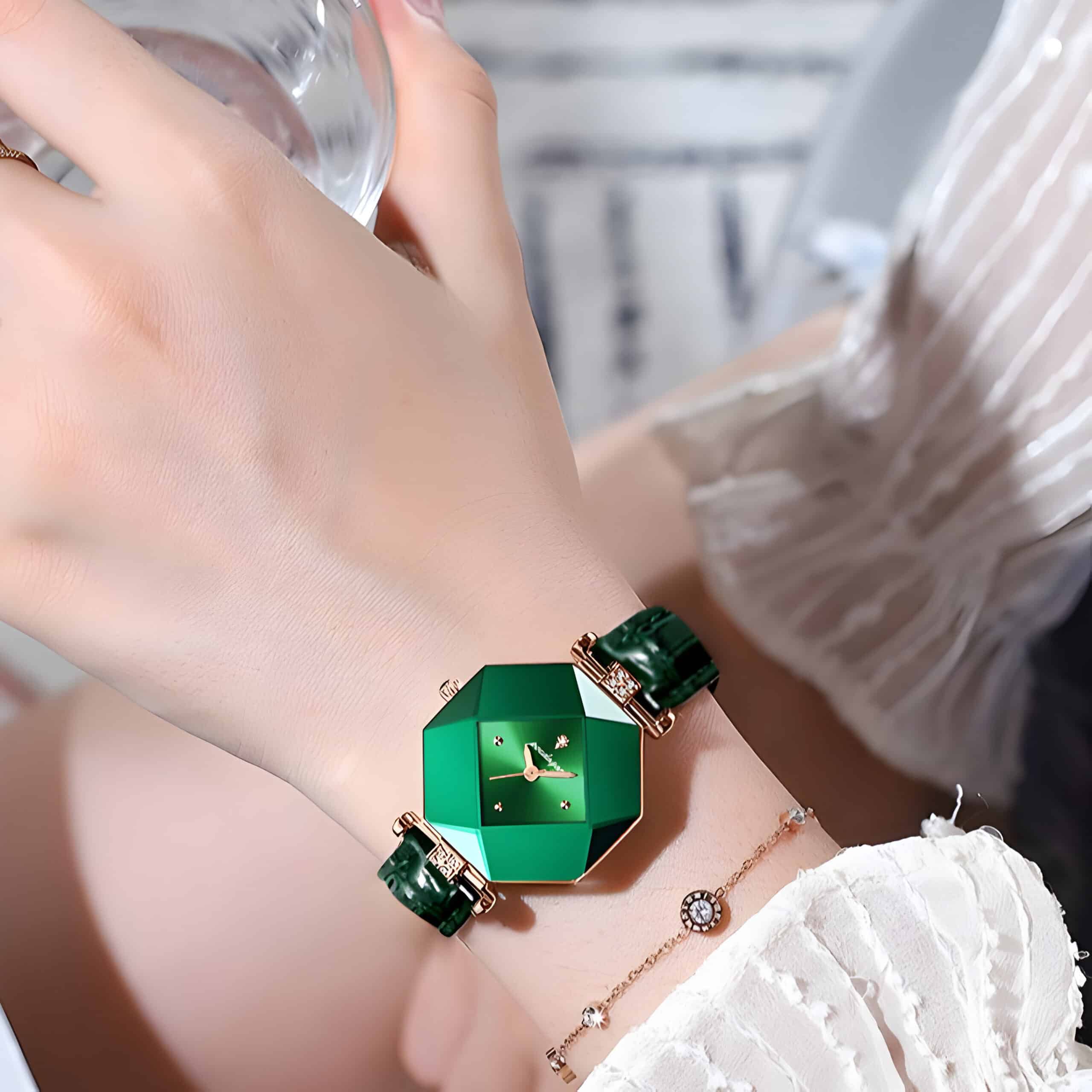 Luxurious green geometric-shaped watch on a woman's wrist, paired with a delicate gold bracelet, showcasing stylish accessories available at Monalisa Store for optical and fashion needs.