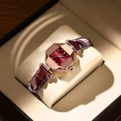 Elegant women’s luxury wristwatch with a red dial and diamond accents, featuring a rich burgundy leather strap, displayed in a high-end watch box. Perfect for stylish accessories and fine jewelry collections.