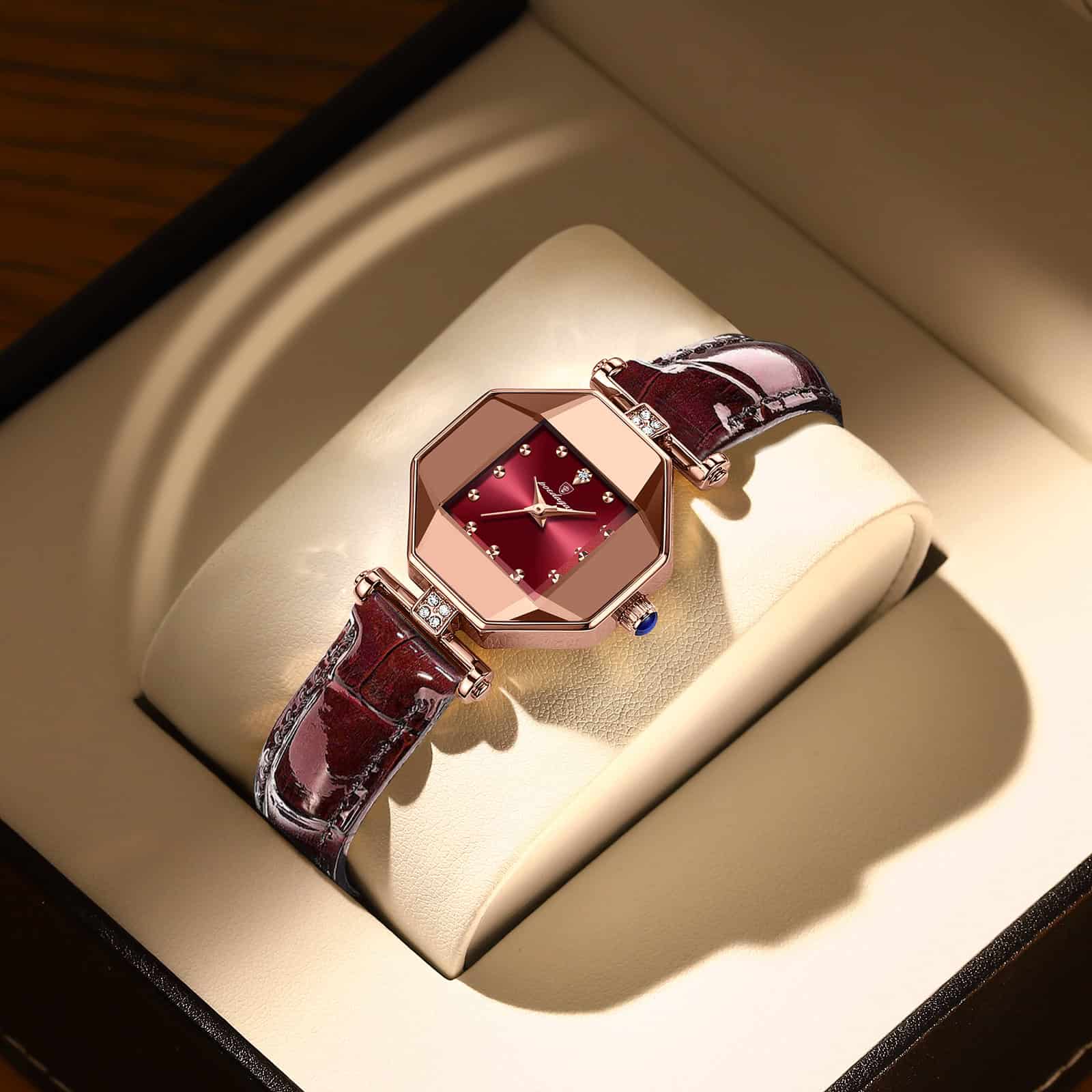 Elegant women’s luxury wristwatch with a red dial and diamond accents, featuring a rich burgundy leather strap, displayed in a high-end watch box. Perfect for stylish accessories and fine jewelry collections.