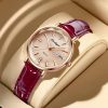 Elegant women's luxury wristwatch with a rose gold case, textured champagne dial, crystal hour markers, and a stylish burgundy leather strap, perfect for fashion-forward accessories.