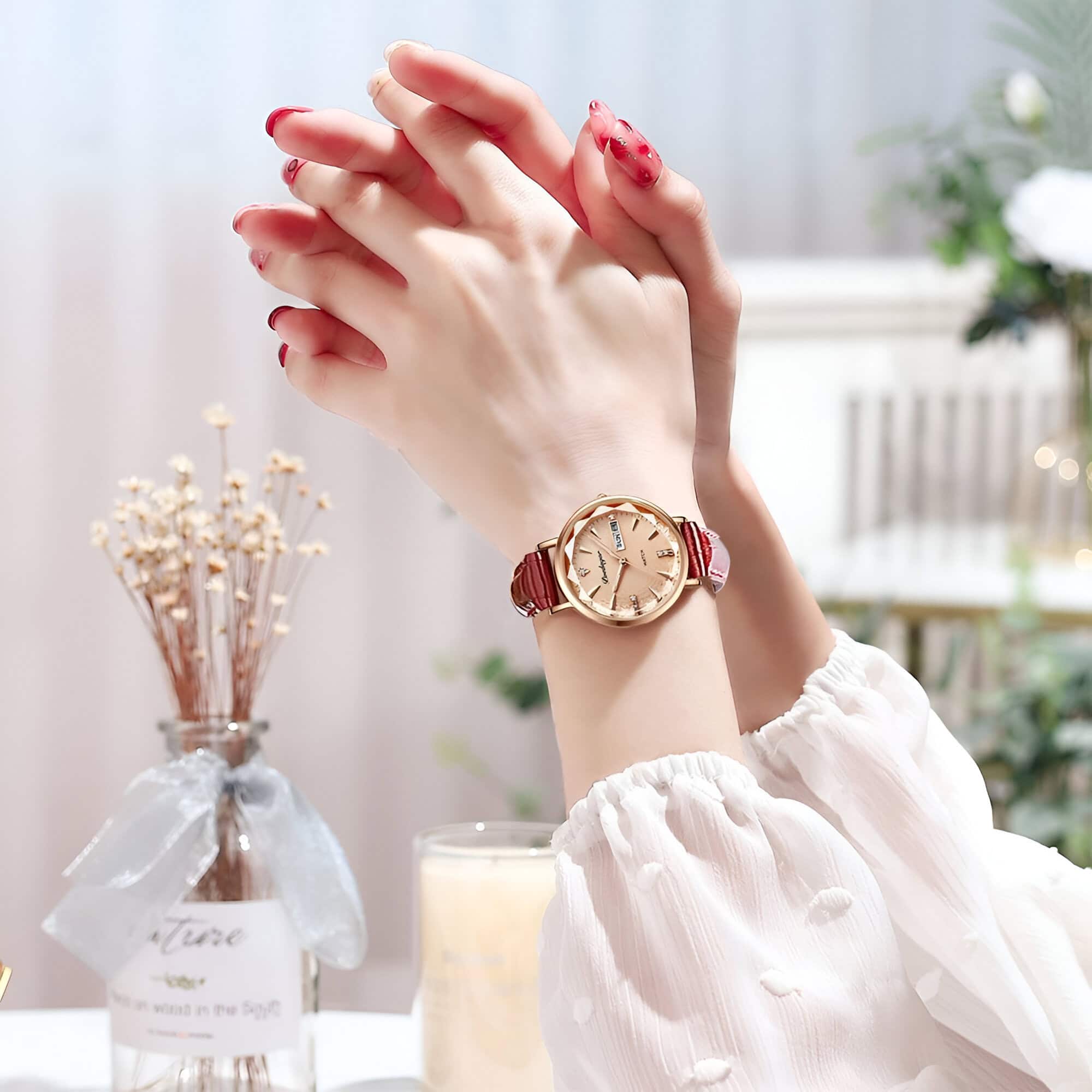 Elegant women's wristwatch with a gold-tone dial and red leather strap, stylishly displayed on a woman's wrist, showcasing luxury accessories ideal for fashion-conscious shoppers.
