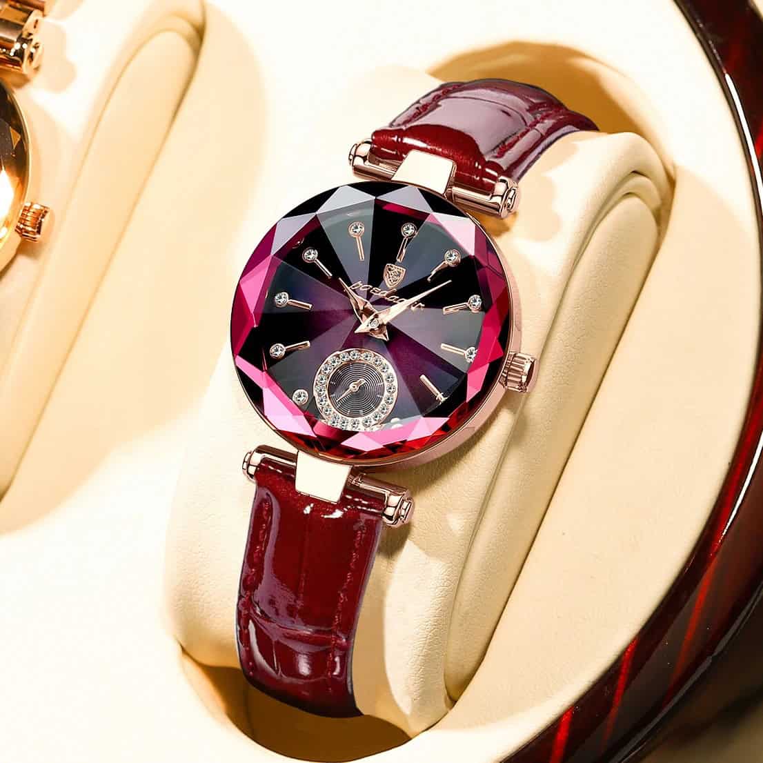 Luxury women's watch with a faceted gemstone-inspired dial, rose gold accents, and a deep red leather strap, perfect for elegant fashion and gift-giving jewelry stores.