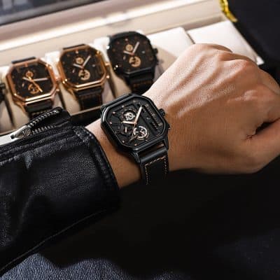Luxurious men's wristwatch with a black leather strap and intricate dial, showcased on a wrist in an elegant store display. Perfect for high-end fashion and luxury watch collectors.