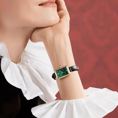 Elegant women's wristwatch with a rectangular green dial, gold-tone case, and black leather strap, perfect for luxury fashion and sophisticated style.