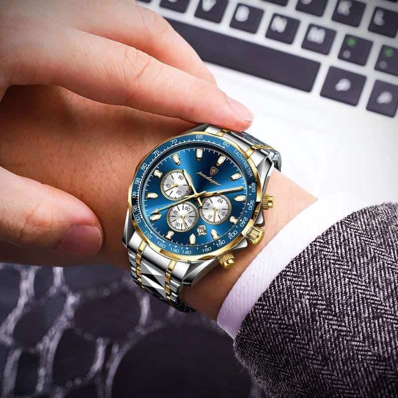 Luxurious men's wristwatch with a blue dial, gold accents, chronograph features, and stainless steel bracelet, ideal for business and formal occasions.