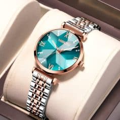Luxurious women's watch with a two-tone metal band and a vibrant turquoise dial, perfect for stylish accessories and elegant timepieces.