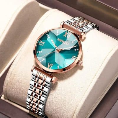 Luxurious rose gold and silver women's wristwatch with a vibrant turquoise dial, Roman numerals, and sparkling accents, perfect for elegant fashion and accessories.