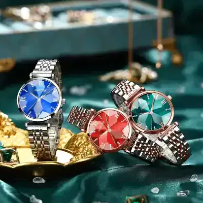 Shiny luxury wristwatches with colorful dials and stainless steel bracelets displayed on a green satin surface at Monalisa Medical Store.
