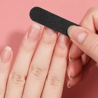 Dark nail buffer block for optimal nail shaping and shine, ideal for professional and casual use.
