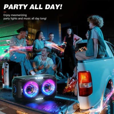 Vibrant outdoor party scene with friends enjoying music from a colorful portable speaker on the back of a pickup truck at night.