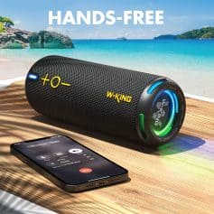 Bluetooth portable speaker on wooden surface with phone, ocean background, summer setting, wireless audio, outdoor music, waterproof speaker, beach vibe, music device, travel speaker, Monalisa Medical.