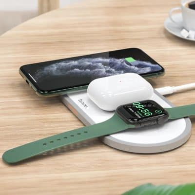 Wireless charging station with smartphone, smartwatch, and earbuds on a wooden desk, emphasizing modern tech accessories at Monalisa Store.